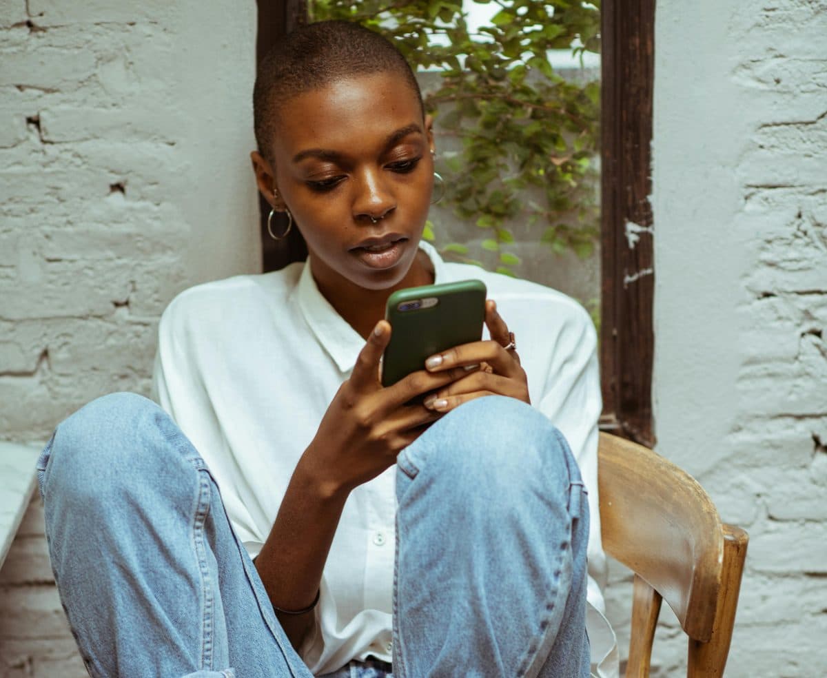 A traveller checking flight options on her phone